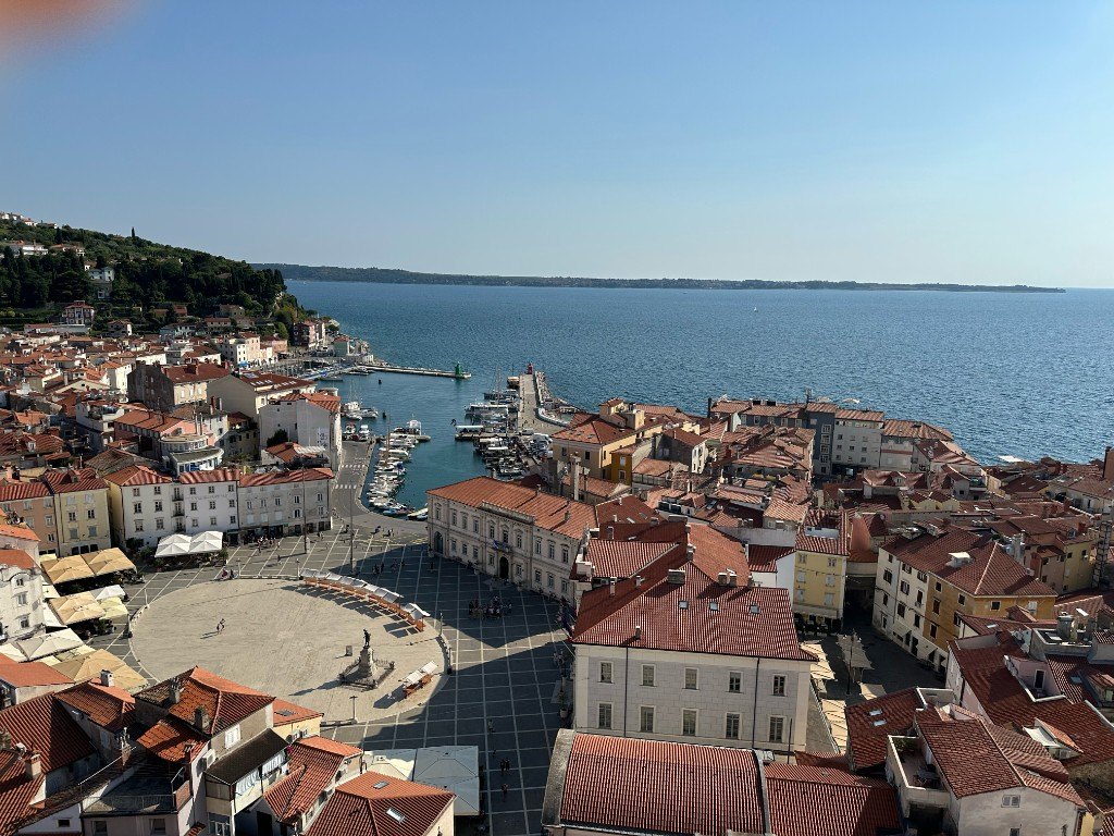 Tartini Square, harbour and terracotta rooftops of Piran seen from the bell tower, with the Gulf of Trieste beyond