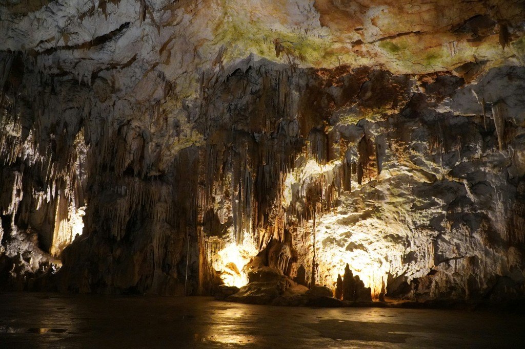 Stalactites and lit limestone walls inside Postojna Cave, Slovenia