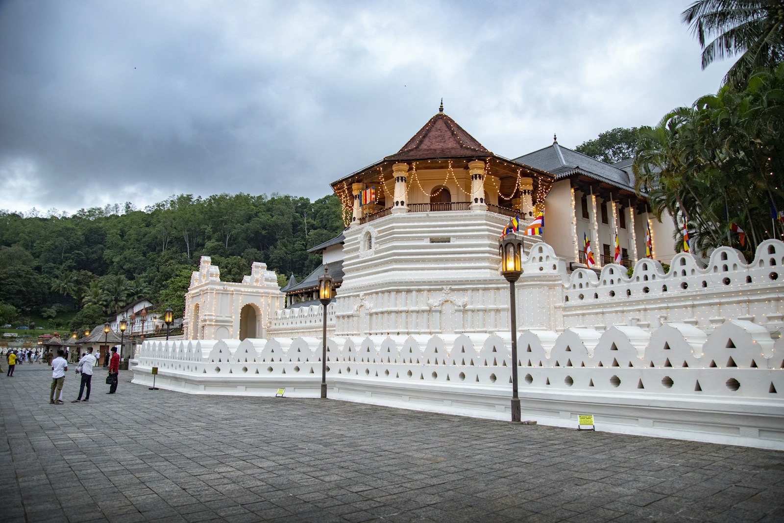 Temple of the Sacred Tooth Relic buildings with gold roof details in softer evening light