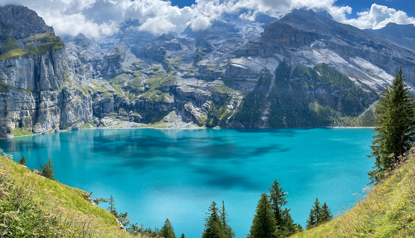 Oeschinensee alpine lake surrounded by steep mountain walls in the Swiss Alps near Kandersteg