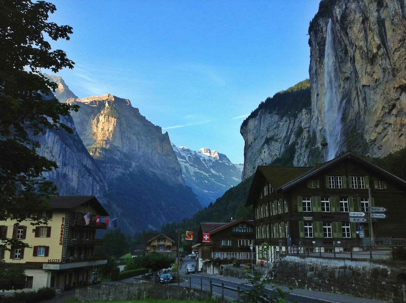Buildings beside a mountain cliff and Staubbach Falls in Lauterbrunnen Valley, Switzerland