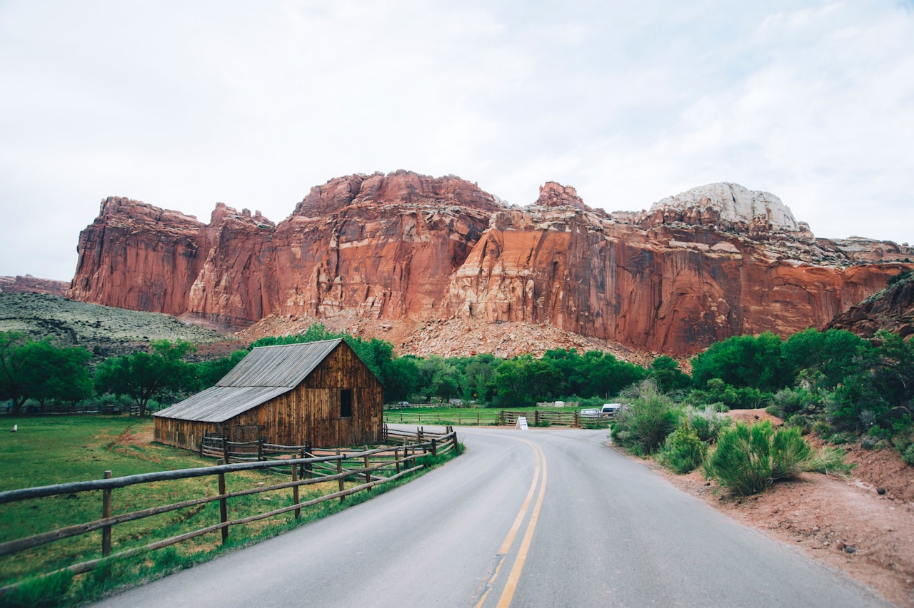 Winding road beside red sandstone buttes in Capitol Reef National Park, Utah