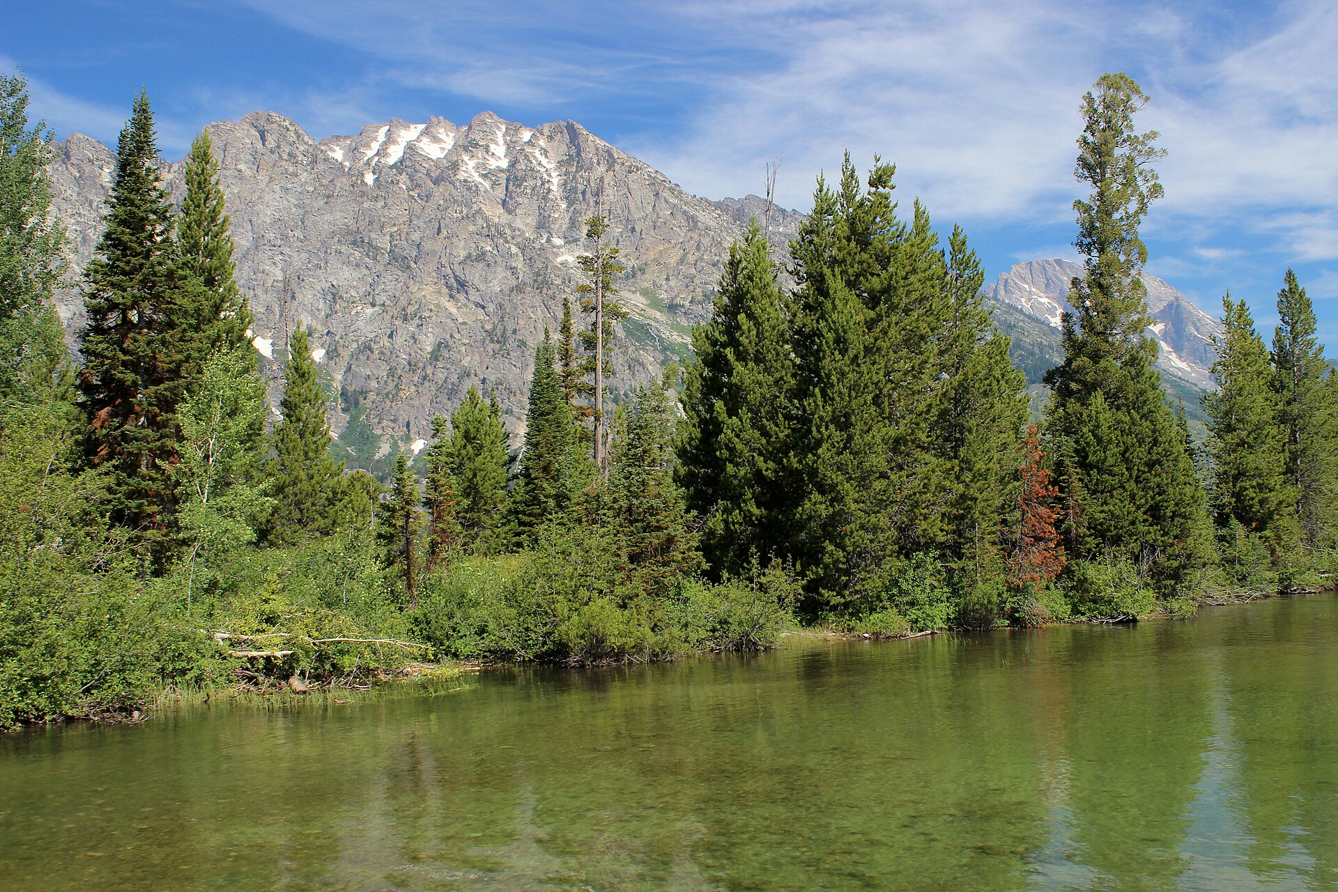 Jenny Lake in Grand Teton National Park with crystal-clear waters reflecting the Teton Range