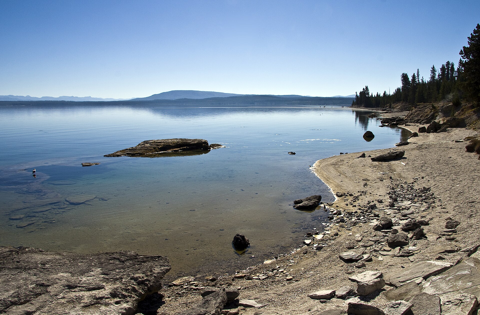 Yellowstone Lake at West Thumb with rocky shoreline and pine forests