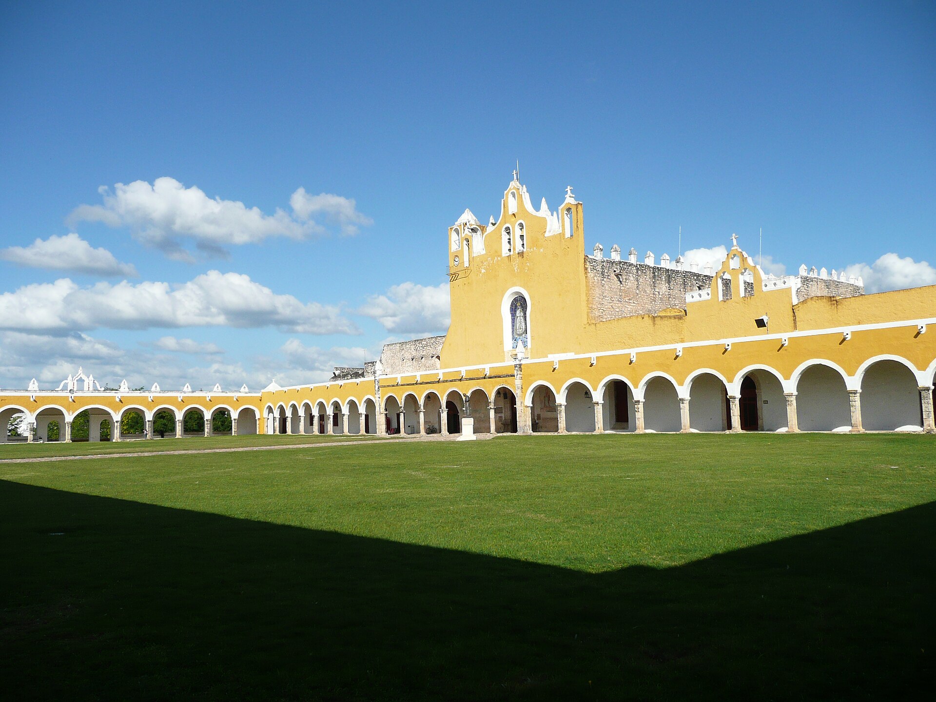 Yellow entrance and arcaded corridors of Convento de San Antonio de Padua in Izamal, Yucatán