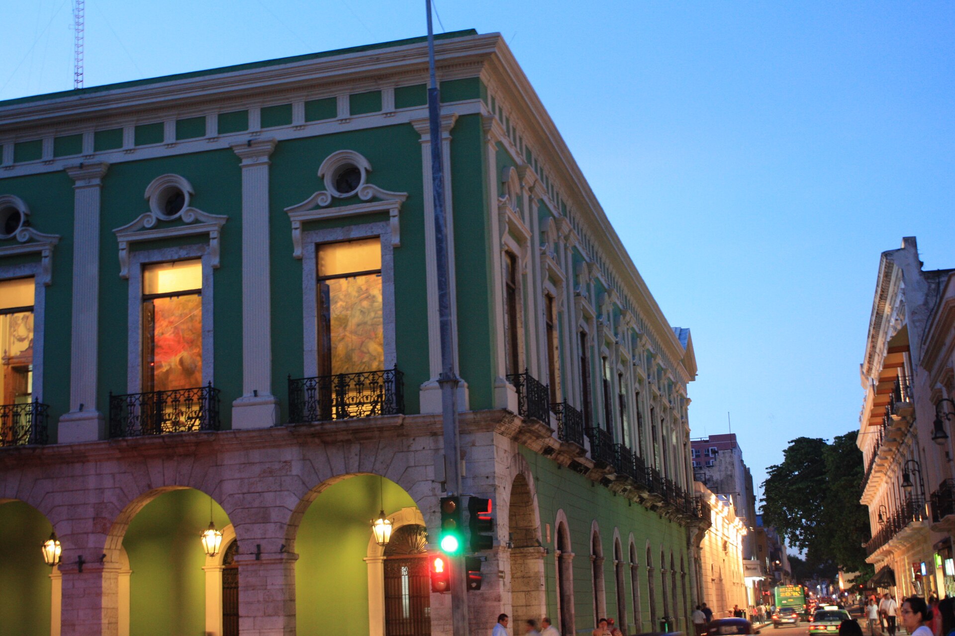Plaza Grande in Mérida, Yucatán, surrounded by colorful colonial-era buildings at dusk