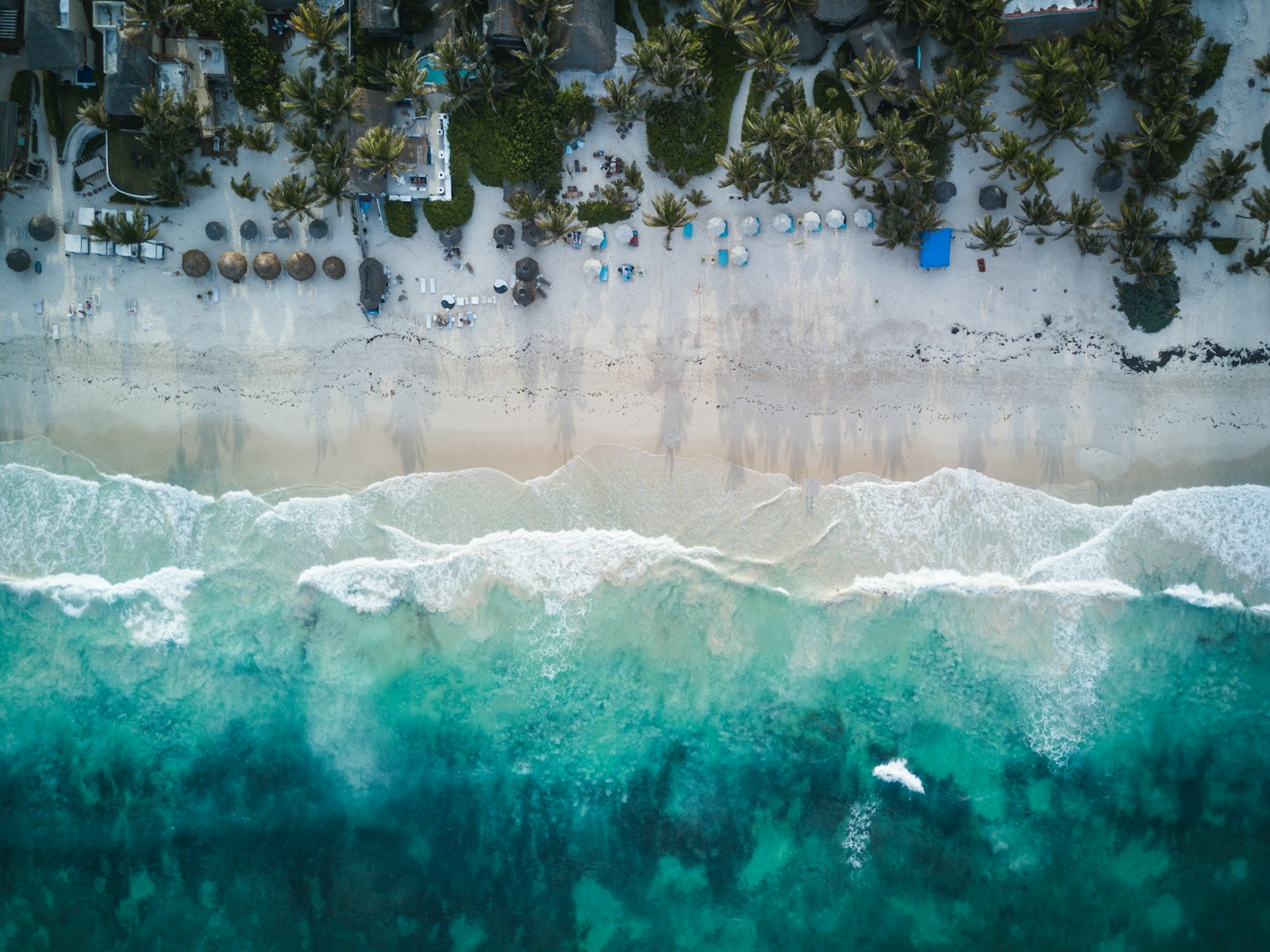 Aerial view of Tulum's Caribbean coastline with white sand, turquoise water and jungle